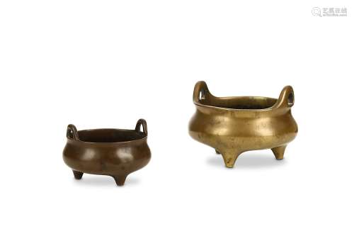 TWO CHINESE BRONZE TRIPOD INCENSE BURNERS. Qing Dynasty. Each on conical feet with loop handles to