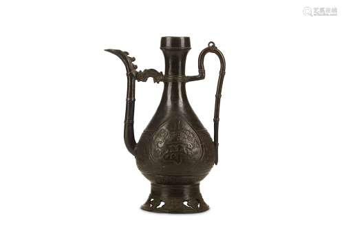 A CHINESE BRONZE EWER. Ming Dynasty, Jiajing Dynasty. The pear-shaped body rising from a tall