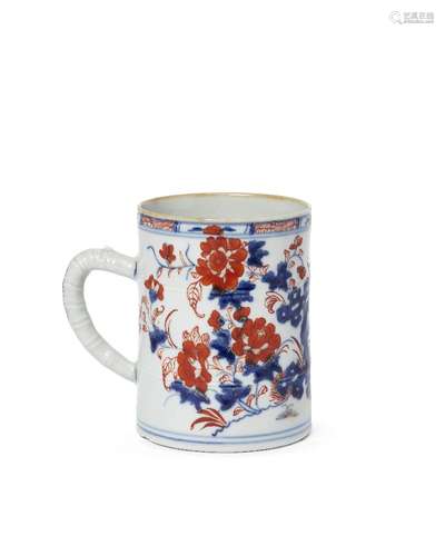 A Chinese porcelain mug, 18th century, painted in the imari palette with stylised rockwork, plants