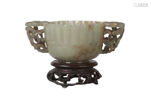 A Chinese green jade twin-handled lobed cup, Ming dynasty, 16th century, with reticulated prunus