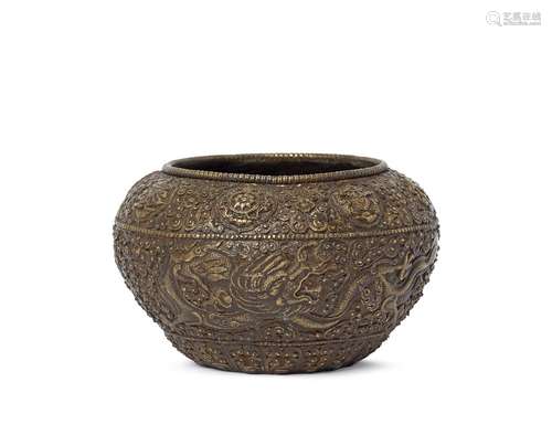 A Sino-Tibetal bronze alms bowl, 18th/19th century, decorated with two dragons on a dense ground