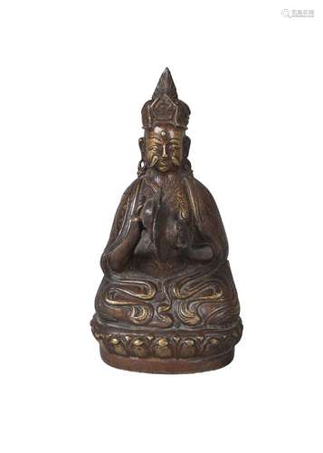 A Tibetan bronze figure, mid-19th century, depicting a bearded deity playing ceremonial Tingsha,