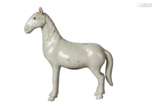 A Chinese porcelain celadon glazed horse, Qing dynasty, 18th century, standing four square, unglazed