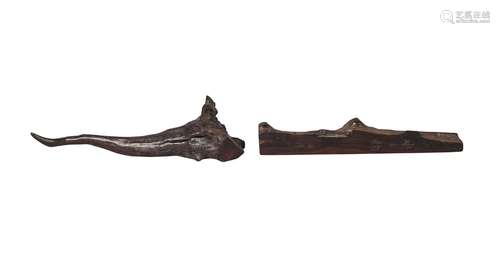 A Chinese zitan scholar's wrist rest, mid-19th century, naturalistically carved to one side, 25cm