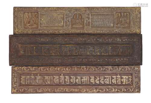 Three Tibetan wood manuscript covers, 15th-16th century, two carved with script inside a floral