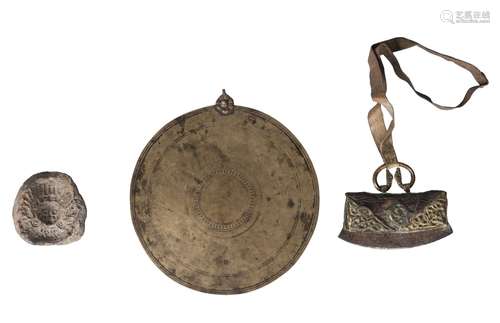 A Tibetan bronze ceremonial disc, 19th century, 21cm diameter, a Tibetan gilt bronze mounted and