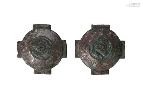 A pair of Chinese bronze ornamental mounts, Warring States, each of circular form with four