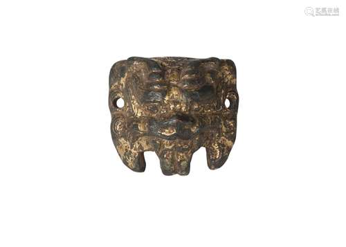 A Chinese gilt bronze applique, Han dynasty, finely modelled as a horned Buddhist lion mask, 4cm x