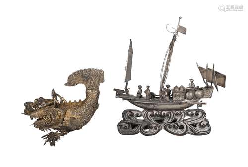 A Chinese silver model of a junk, late 19th/early 20th century, resting on a carved hard wood