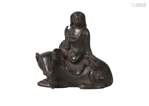 A Chinese bronze scroll weight, Ming dynasty, 17th century, modelled as Guanyin seated atop a