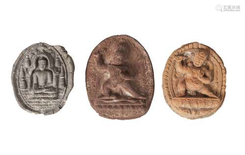 Three Tibetan terracotta votive plaques, 18th/19th century, one depicting Buddha seated,