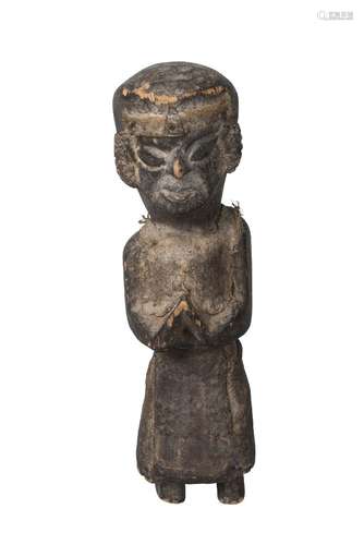 A Nepalese wooden ritual figure, 19th century, with applied white metal decoration to ears and cloth