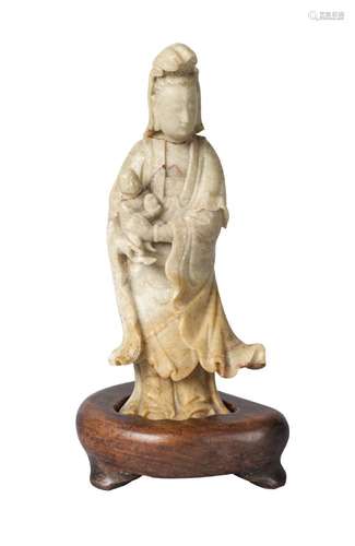 A Chinese soapstone carving of Guanyin and a child, 18th/19th century, carved standing, with cloud-