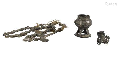 A silvered metal miniature censer, 19th century, a silver model of a Buddhist lion, and a silvered