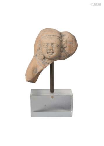 An Indian terracotta fragment, Shunga period, 3rd-2nd century BCE, modelled the head of a deity, 6cm