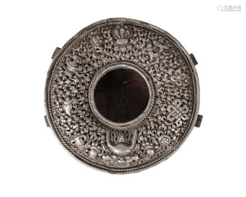 A Tibetan silver and copper backed Gau, 19th century, the cover pierced and repousse decorated