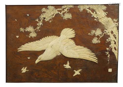 A Japanese wood and ivory inlaid rectangular panel, late 19th/early 20th century, depicting an eagle