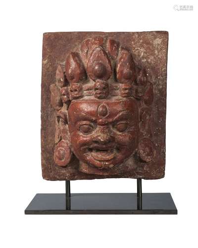 A Nepalese terracotta head of Bhajrava, early 20th century, wearing a crown adorned with skulls,