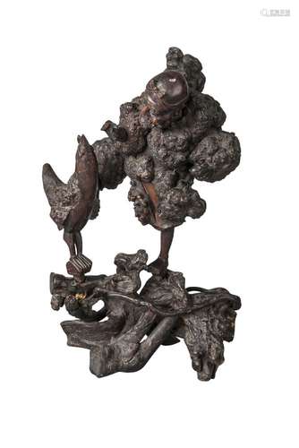 A Japanese rootwood carving of a traveller with a chicken, late 19th century, carved with right