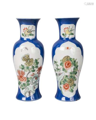 A pair of Chinese porcelain baluster vases, 19th century, painted with panels in famille verte