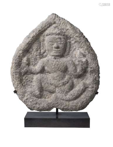 A South East Asian stone stele, 10th century, carved with a male deity, 26cm x 23cm