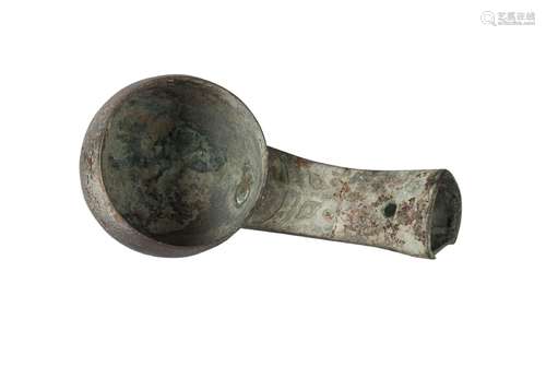 A Chinese bronze ritual ladle, Shang dynasty, the deep bowl with rounded sides, the stem cast with a