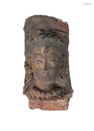 A Tibetan painted terracotta head of Shiva, 19th century, with later painted features, 25cm high