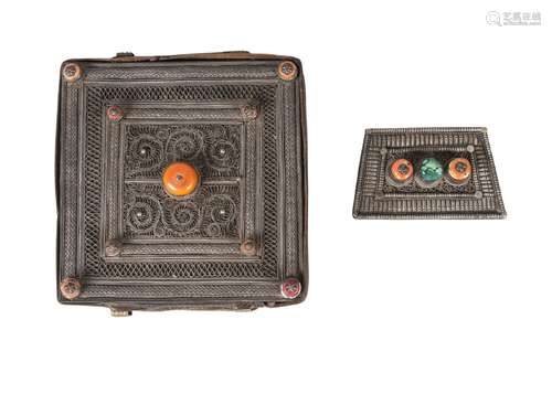 A Tibetan silver and wood backed Gau and a similar buckle, 19th century, the Gau filigree