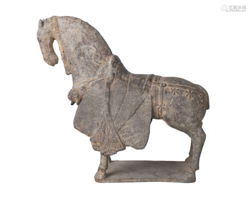 A Chinese finely modelled grey pottery figure of a caparisoned horse, Northern Wei Dynasty, standing