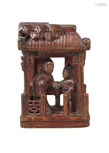 A Chinese painted and lacquered wood carving, late 19th century, depicting two figures beneath a