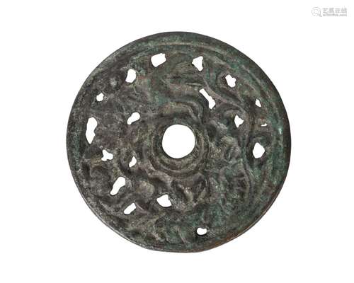 A Chinese bronze Han-style circular plaque, late Qing dynasty, pierced with animals and floral