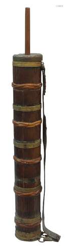 A Tibetan wood and brass mounted travelling grain mill, 19th century, with leather strap, 114cm high