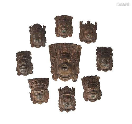 A collection of nine Nepalese copper alloy mask appliques, 19th century, of various deities, now