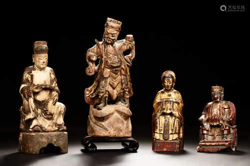 FOUR PARCEL GILT WOOD CARVED FIGURES