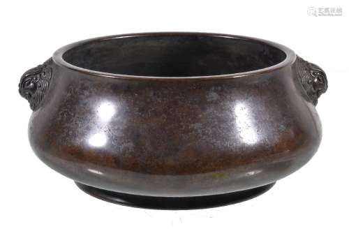 A Chinese bronze censer, with a mottled brown patina, of squat bulbous shape, with opposing grinning