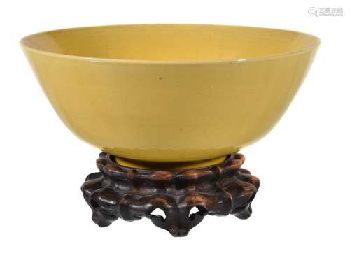 A Chinese yellow-glazed bowl, with deep rounded sides rising from a very short foot ring to a