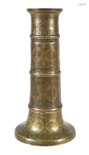 A Safavid brass candlestick, Persia, 17th century and later, of faceted columnar form, the flared