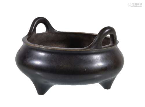 A Chinese bronze incense burner, ding, cast of compressed globular form supported on three
