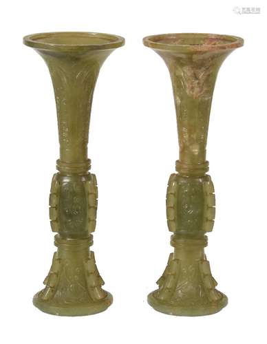 A pair of Chinese celadon and russet jade archaistic vases, gu, 19th or early 20th century, of