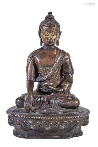 A Tibetan bronze figure of Buddha, seated in padmasana on a lotus throne, his right hand in