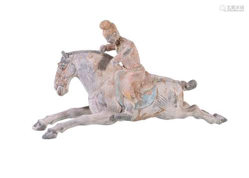 A Chinese painted pottery horse and rider, depicting a young lady possibly playing polo on her