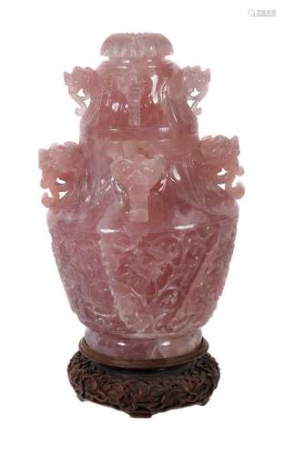 A large Chinese rose quartz vase and cover, the tapering body carved with scrolling foliage, the