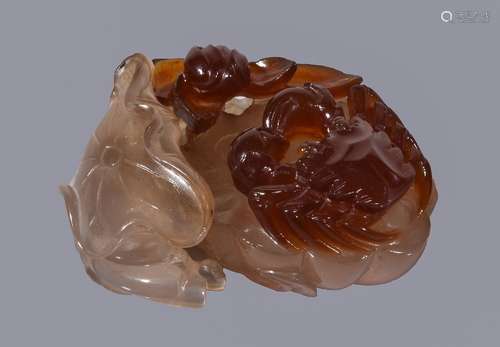 A Chinese agate 'crab and lotus' carving, the smoky-grey chalcedony section of the stone carved as a