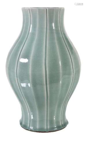 A fine Chinese celadon-glazed vase, Qing Dynasty, Qianlong mark and period, the baluster body