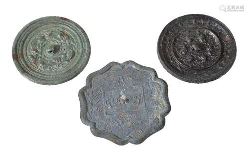 Two Chinese bronze mirrors, Tang Dynasty, one cast with a central knop formed by a crouching beast