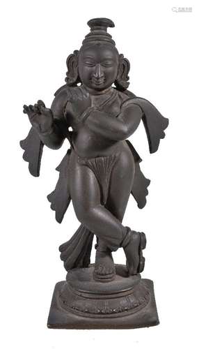 A bronze figure of Krishna playing the flute, Southern India, 19th century, the youthful deity