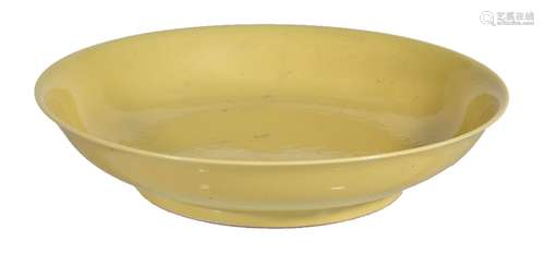 An Imperial style yellow-glazed dish, the shallow rounded sides supported on a tapered foot, covered