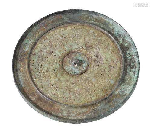 A large Chinese bronze mirror, Tang Dynasty, with later () jade inlay, the border cast with