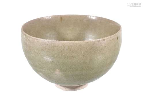 A Chinese celadon stoneware bowl, with deep rounded sides, the raised foot and part of underside