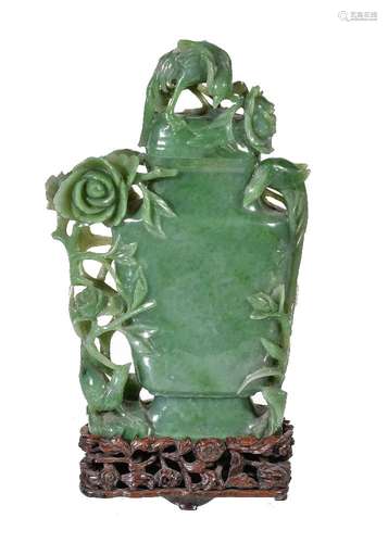 A Chinese green jadeite vase and cover, circa 1900-1920, with mottled mutton fat inclusions, of